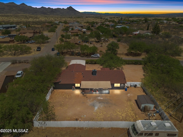 aerial view at dusk featuring a mountain view
