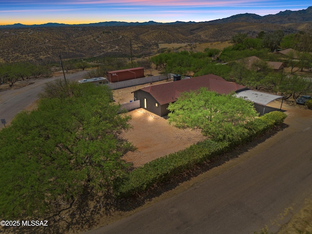 aerial view at dusk featuring a mountain view
