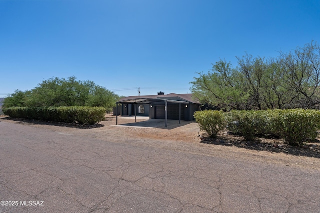 view of front facade featuring a garage, aphalt driveway, and a carport