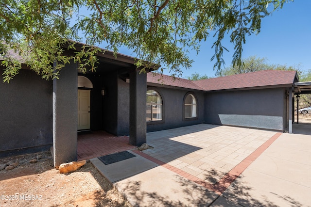 view of front facade featuring a patio area and stucco siding