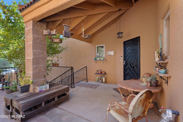 1408 W Kandy Ct, Tucson, AZ 85745 - view of exterior entry with stucco siding and a patio area