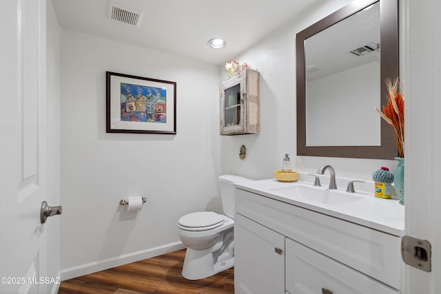 1408 W Kandy Ct, Tucson, AZ 85745 - half bath with toilet, wood finished floors, vanity, baseboards, and recessed lighting