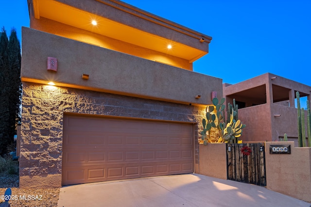 1408 W Kandy Ct, Tucson, AZ 85745 - view of front of home with concrete driveway, fence, an attached garage, and stucco siding