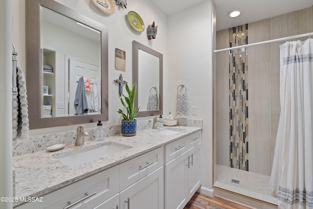 1408 W Kandy Ct, Tucson, AZ 85745 - bathroom with tiled shower, double vanity, and wood finished floors