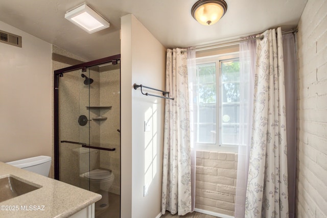 full bath featuring vanity, toilet, visible vents, and a stall shower