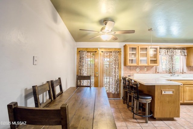 interior space featuring french doors, ceiling fan, and light tile patterned flooring