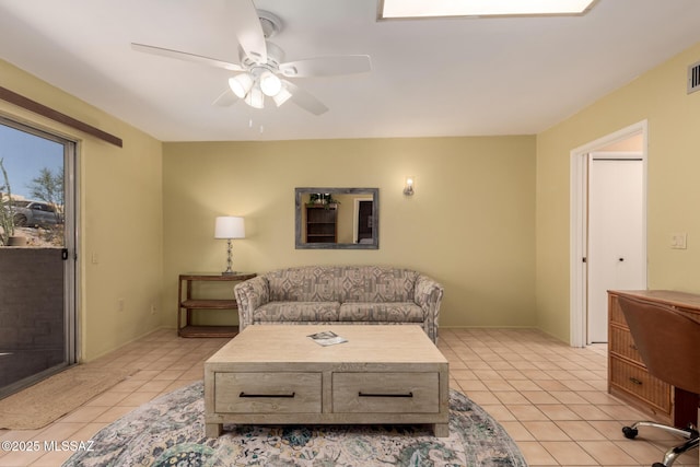 living room featuring light tile patterned floors, a ceiling fan, and visible vents