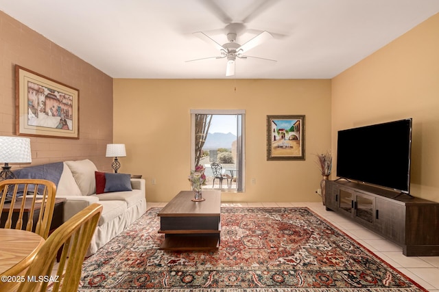 living area featuring a ceiling fan and light tile patterned floors