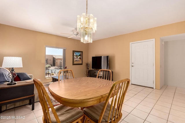 dining area with light tile patterned floors and ceiling fan with notable chandelier