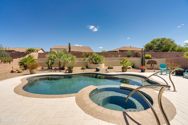 view of pool featuring a fenced backyard, a patio area, and a pool with connected hot tub