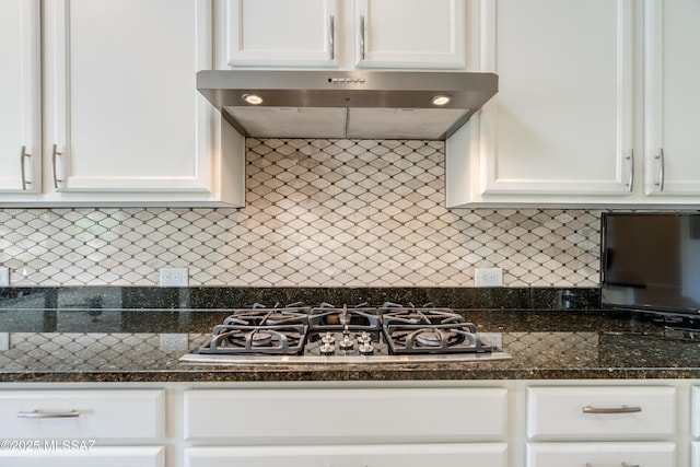 kitchen with white cabinets, extractor fan, and gas stovetop