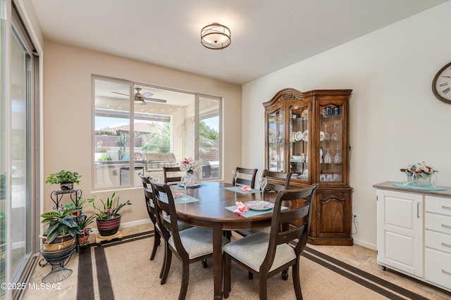 dining area with baseboards and ceiling fan