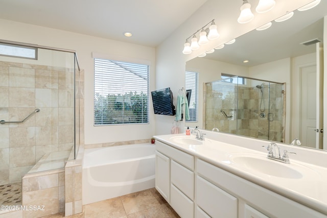 bathroom featuring a garden tub, a sink, visible vents, and a shower stall