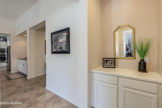 corridor featuring baseboards