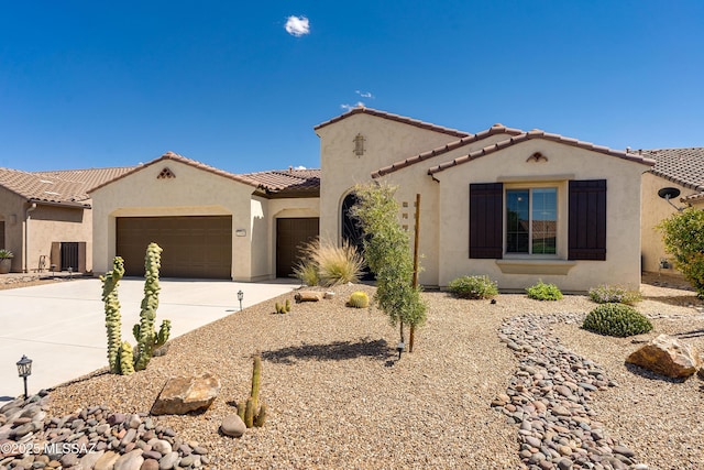 2594 E Keyes Ct, Green Valley, AZ 85614 - mediterranean / spanish-style home featuring a tiled roof, stucco siding, driveway, and a garage