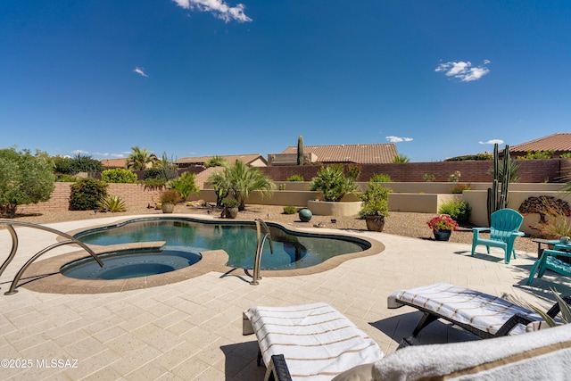 view of pool featuring a fenced in pool, a fenced backyard, an in ground hot tub, and a patio area