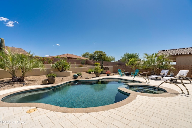 view of pool with an in ground hot tub, a fenced in pool, a fenced backyard, and a patio area