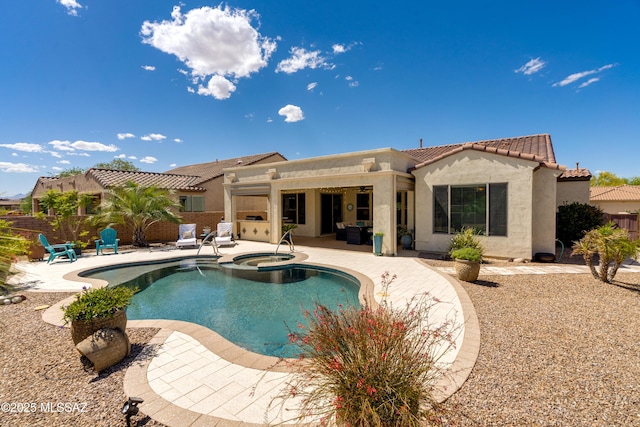 rear view of house with a patio area, stucco siding, a tile roof, and fence