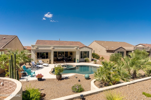 view of swimming pool with a patio and a pool with connected hot tub