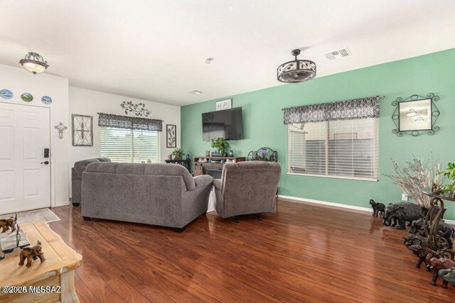 630 E Racine Pl, Casa Grande, AZ 85122 - living room featuring visible vents, baseboards, and wood finished floors