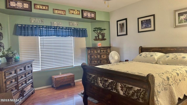 630 E Racine Pl, Casa Grande, AZ 85122 - bedroom with baseboards, wood finished floors, and multiple windows