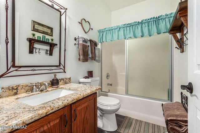 630 E Racine Pl, Casa Grande, AZ 85122 - bathroom with toilet, tile patterned flooring, shower / bath combination with glass door, and vanity
