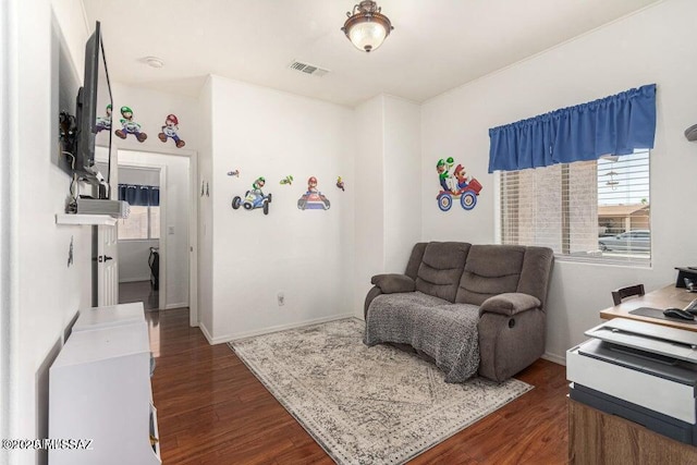 630 E Racine Pl, Casa Grande, AZ 85122 - living area featuring visible vents, dark wood-type flooring, and a healthy amount of sunlight