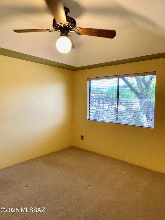 empty room with ceiling fan and carpet