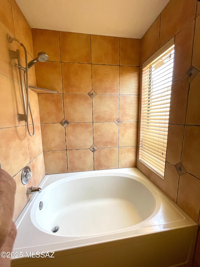 bathroom with a washtub and walk in shower