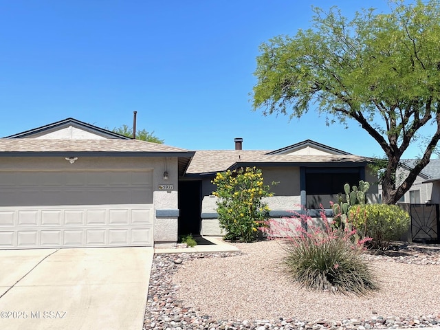 ranch-style house with a garage, roof with shingles, stucco siding, and driveway