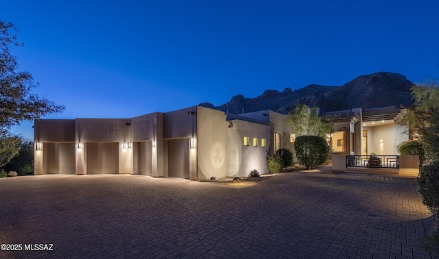 1743 E Sahuaro Blossom Pl, Tucson, AZ 85718 - pueblo-style home with an attached garage, a mountain view, stucco siding, and driveway