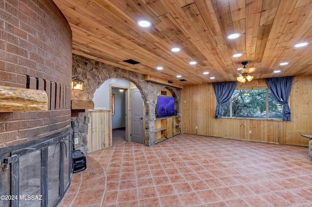 unfurnished living room featuring recessed lighting, arched walkways, a ceiling fan, and visible vents