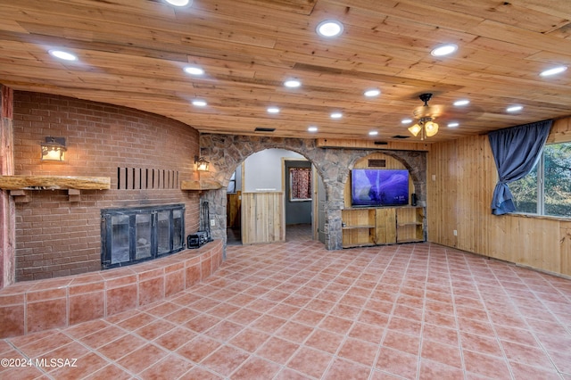unfurnished living room with a brick fireplace, recessed lighting, tile patterned floors, and wood ceiling