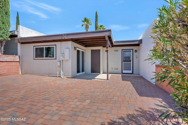 back of property featuring a patio area