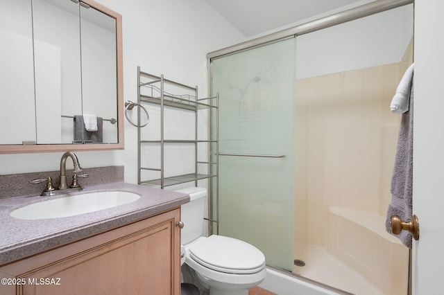 full bath with vanity, toilet, and a shower stall