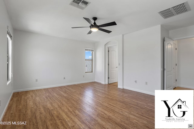 interior space featuring baseboards, ceiling fan, visible vents, and wood finished floors