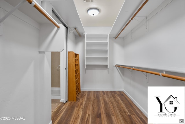 spacious closet featuring visible vents and wood finished floors