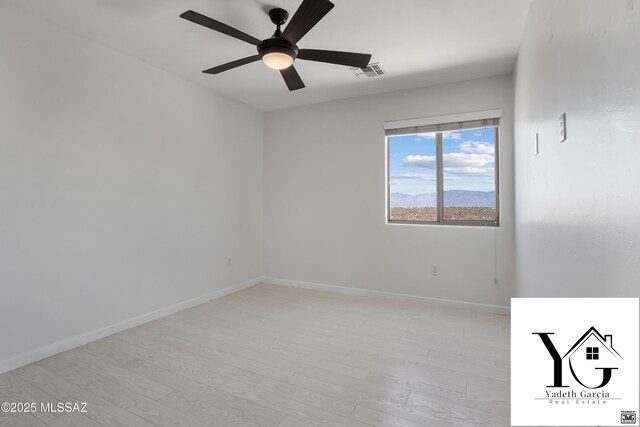 unfurnished room featuring baseboards, ceiling fan, visible vents, and light wood-style flooring