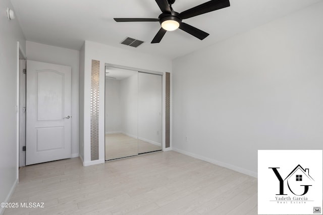 unfurnished bedroom featuring visible vents, a closet, baseboards, a ceiling fan, and light wood finished floors
