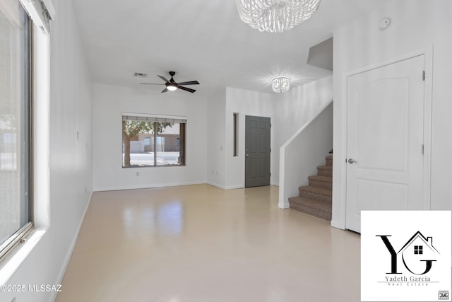 unfurnished living room with stairs, baseboards, visible vents, and finished concrete floors