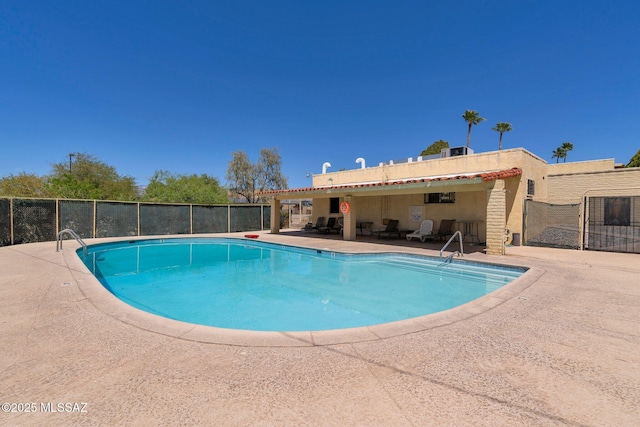 pool with fence and a patio area