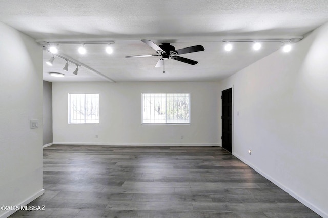 unfurnished room featuring track lighting, a ceiling fan, and plenty of natural light