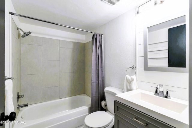 full bathroom featuring a textured wall, shower / bath combo, vanity, toilet, and visible vents