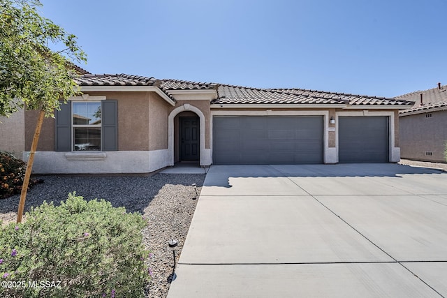 11601 W Granville Dr, Marana, AZ 85653 - mediterranean / spanish-style house with an attached garage, concrete driveway, a tile roof, and stucco siding