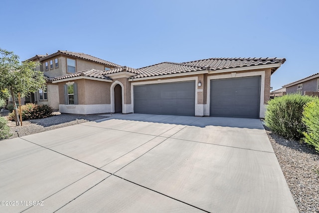 11601 W Granville Dr, Marana, AZ 85653 - mediterranean / spanish-style house with a tiled roof, an attached garage, driveway, and stucco siding