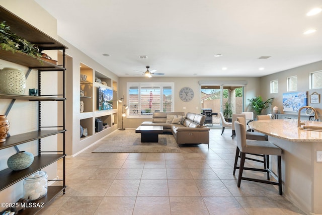 7084 W Cliff Spring Trl, Marana, AZ 85658 - living room featuring built in shelves, ceiling fan, recessed lighting, light tile patterned flooring, and baseboards