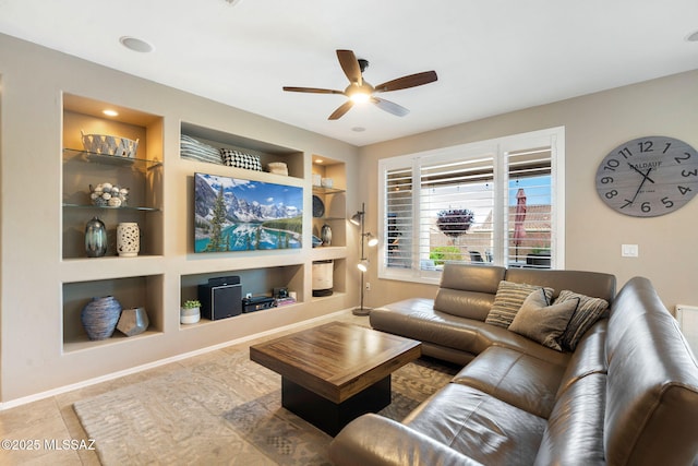 7084 W Cliff Spring Trl, Marana, AZ 85658 - tiled living room featuring built in features, ceiling fan, and baseboards