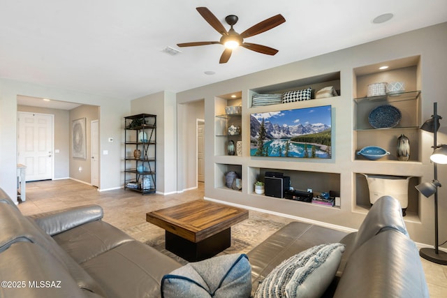 7084 W Cliff Spring Trl, Marana, AZ 85658 - living area with built in shelves, ceiling fan, baseboards, and tile patterned flooring
