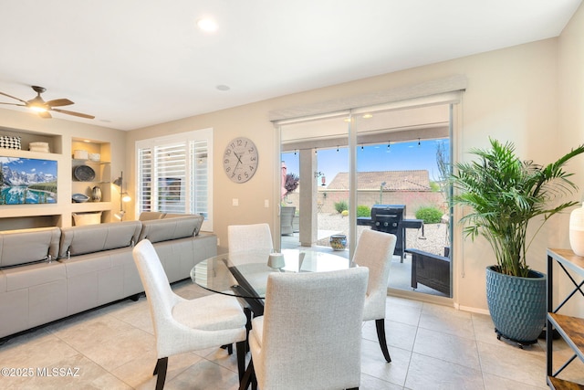 7084 W Cliff Spring Trl, Marana, AZ 85658 - dining space featuring built in shelves, light tile patterned floors, and a ceiling fan