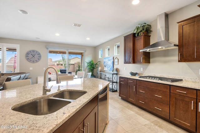 7084 W Cliff Spring Trl, Marana, AZ 85658 - kitchen with wall chimney range hood, a sink, appliances with stainless steel finishes, light stone counters, and light tile patterned flooring